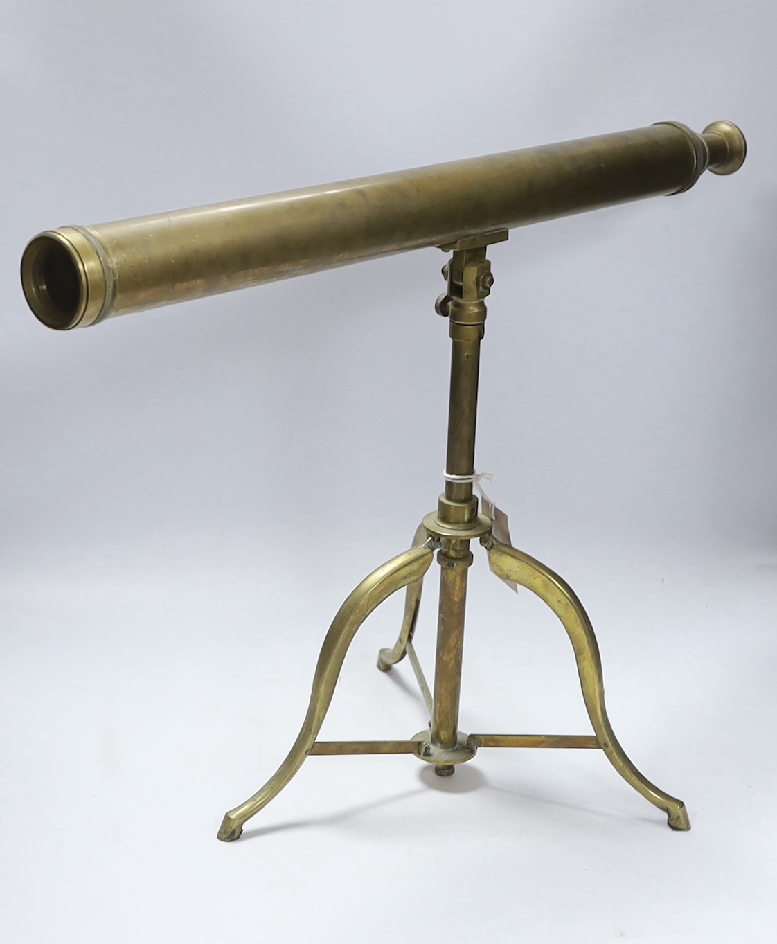 A brass tripod telescope, 65cm wide
